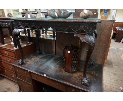 A good late 19th century carved mahogany side table, in the Chippendale style, with shaped top above a pierced frieze and cab