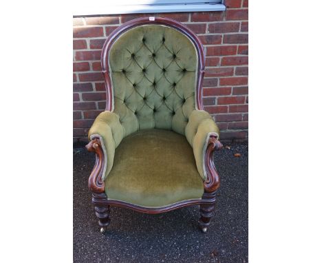 A Victorian carved mahogany and button upholstered occasional armchair.&nbsp; 