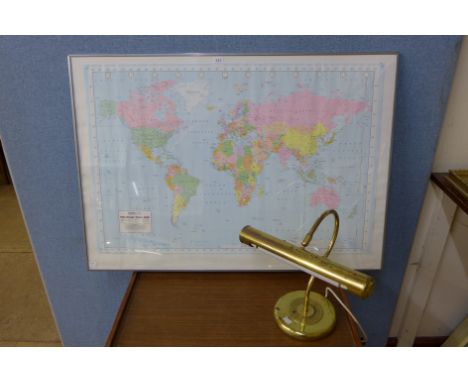 A Political wall map of the world and a student's desk lamp