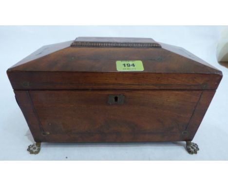 A Regency mahogany sarcophagus tea caddy with brass line inlay, on gilt brass paw feet. 12' wide