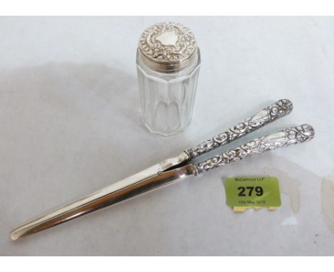 A pair of silver hafted glove stretchers and a silver topped dressing table jar