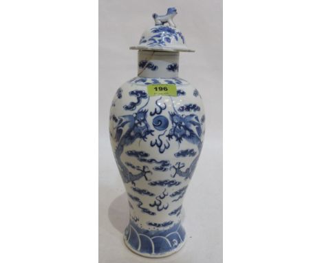 A Chinese blue and white inverted baluster vase with cover, painted with two dragons in pursuit of the flaming pearl. Four fi