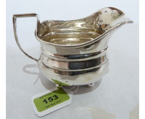 A George V silver helmet cream jug. London 1913. 5' long over handle. 3ozs 15dwts. Dents