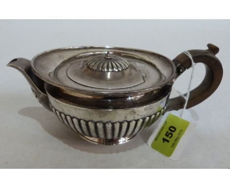 A Victorian silver half-gadrooned teapot of helmet form, stamped Dobson, Piccadilly London 1880. 8' long over spout and handl