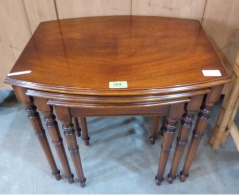 A nest of three mahogany bow-fronted occasional tables