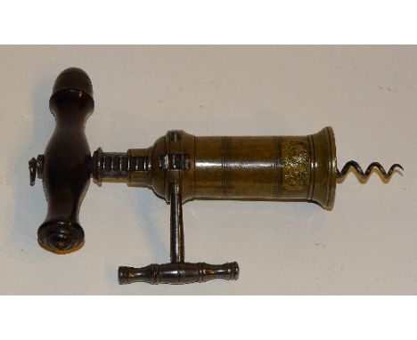 An antique patent corkscrew, the turned wood handle with suspension ring and adjustable screw height mechanism, stamped paten