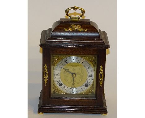 An Elliot mantel clock retailed by Hamilton & Inches Edinburgh, with gilt metal carry handle above gilded dial with silvered 