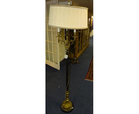 A French style gilt metal and ebonised floor lamp with shade, the three gilt metal scroll candelabra branches to the top abov