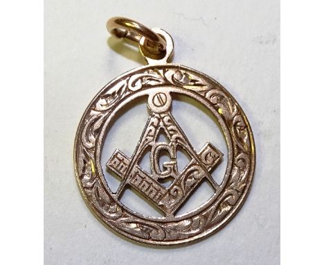 A 9ct gold Masonic fob, with compass and set square set in the round with foliate decoration, stamped 375, 3.9g