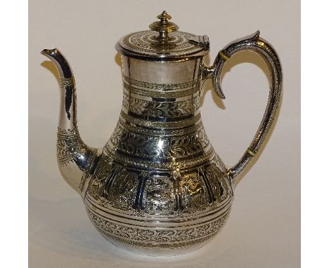 A white metal tea pot by Edward & Sons of London/Glasgow, with allover Anglo-Indian foliate decoration and the 12 signs of th