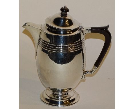 A silver hot water pot, hallmarks for Sheffield 1928 James Deakin & Sons, of plain design with gadrooned decoration to top, e