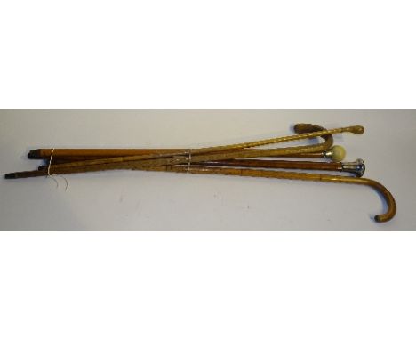 Five walking sticks, to include a silver topped malacca, an ivory topped malacca, bamboo sticks and a hexagonal stick, talles