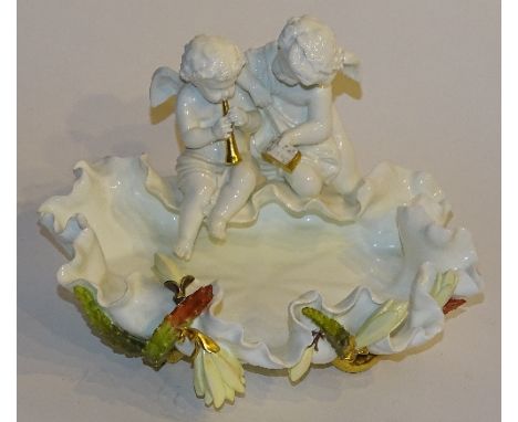 A Moore's porcelain frilly rim dish circa late 19th/early 20th century, with two winged putti children sitting to top, one pl