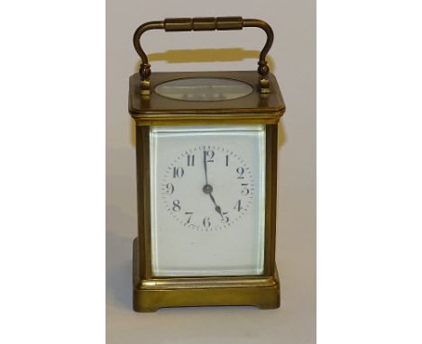 A French brass carriage clock, the white enamel dial with Arabic numerals, 17cm high
