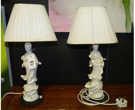 A pair of Chinese blanc de chine table lamps modelled as Guanyin, with shades, figures measure 31cm high, overall lamp 50cm h