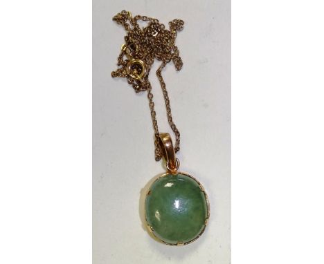 A 9ct gold jade pendant on chain, the smooth round green jade cabochon held in claw setting, stamped 375 to clasp, 6.6g