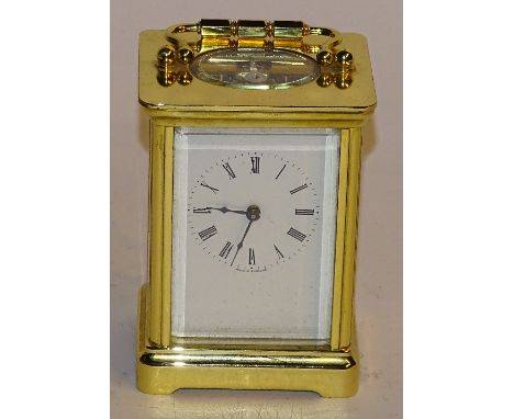 A brass carriage clock, the white enamel dial with Roman numerals, no name marked to front, 'Made in England' written to bott