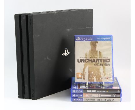 PlayStation 4 Pro (PS4 Pro) black console with 4 games Games include: Uncharted: The Nathan Drake Collection [sealed], Battle