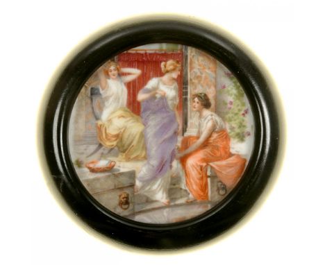 A CONTINENTAL PORCELAIN PLAQUE, PRINTED AND PAINTED WITH THREE CLASSICAL MAIDENS, 9.5CM DIAM INCLUDING TURNED EBONISED FRAME,