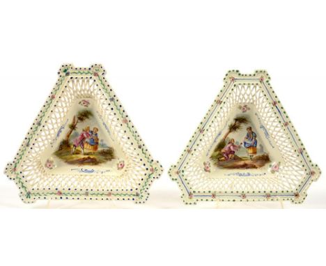 A PAIR OF TRIANGULAR CONTINENTAL CREAM GLAZED EARTHENWARE OPENWORK STANDS, PAINTED WITH LOVERS AND FLOWERS, 21.5CM L, PAINTED