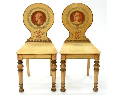 A PAIR OF PAINTED HALL CHAIRS, THE ROUND BACK PAINTED EN GRISAILLE WITH PORTRAIT MEDALLIONS OF WARRIORS, ON FLUTED TAPERING T