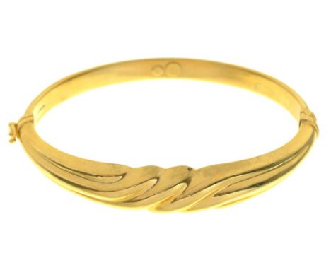 A GOLD BANGLE, MARKED 750, 13G++LIGHT WEAR CONSISTENT WITH AGE