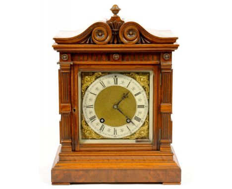 A GERMAN WALNUT AND BURR WALNUT ARCHITECTURAL CASED MANTEL CLOCK WITH CARVED PEDIMENT, FLUTED PILASTERS AND PANELLED SIDES, L