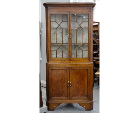 A VICTORIAN OAK CORNER CUPBOARD ON BRACKET FEET, THE UPPER PART GLAZED, 204CM H, 98CM W