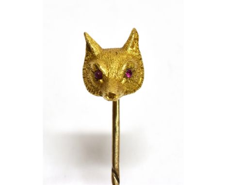 A YELLOW GOLD FOX HEAD STICKPIN  Set with ruby eyes, unmarked, the head assessed as 9ct gold, gross weight approx. 4.2 grams 