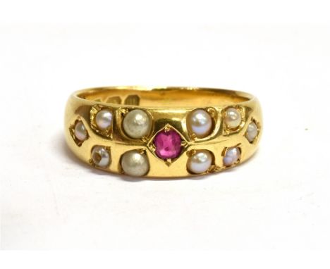 A VICTORIAN RUBY AND SEED PEARL SET 18CT GOLD BAND RING Small ruby to centre with half round seed pear surround, hallmarked B