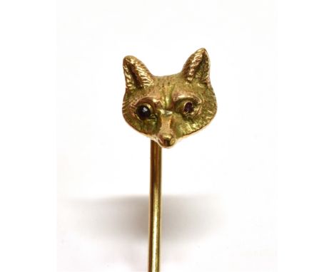 A YELLOW GOLD FOX HEAD STICKPIN  Set with ruby eyes, unmarked the head assessed as 9ct gold, gross weight, approx. 5.3 grams 