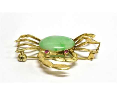 A JADEITE SINGLE STONE SET CRAB BROOCH the central oval cabochon cut jadeite 18mm x 12mm, small synthetic ruby eyes, unmarked