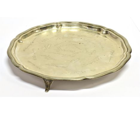 A SILVER TRAY  with facsimile signatures, lobed rim and line, on three feet, hallmark for Sheffield 1922, makers William Hutt