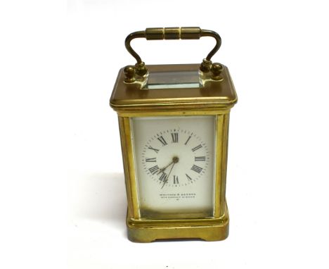 A MINATURE BRASS CASED CARRIAGE CLOCK  the enamel dial inscribed 'WALTERS &amp; GEORGE 270 REGENT CIRCUS W', 9cm high