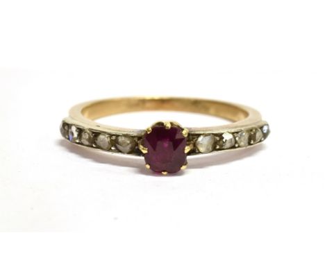 AN EARLY 20TH CENTURY RUBY AND DIAMOND SET RING The single small cushion cut ruby 4.5mm x 3.8mm, a total of ten rose cut diam