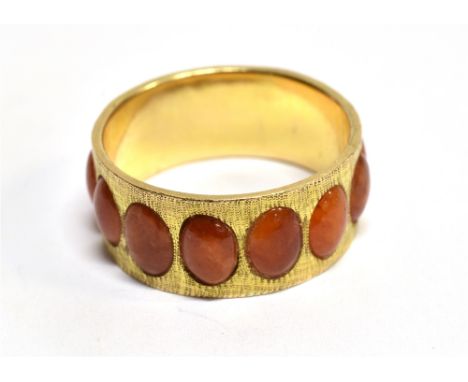 A FIRE OPAL  full set 14ct yellow gold band ring with textured finish, gross weight 4.4 grams, stamped 14k Condition Report :