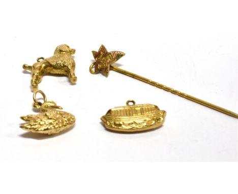 THREE 9CT GOLD LOOSE CHARMS and a 9ct gold three legged Manx stick pin, the charms comprising a swan, a poodle and Noah's Ark