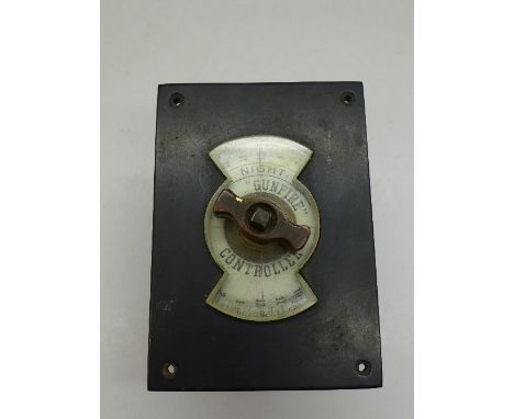An old gas street light timer, marked Night and The "Gunfire" Controller