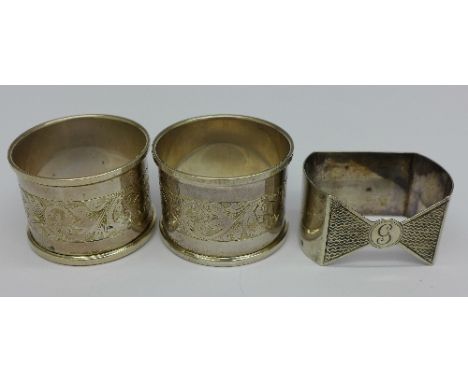 A pair of silver napkin rings and one other silver napkin ring, 57g