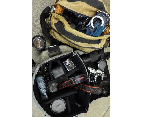 Two camera bodies, Canon AE-1 and Praktica BC3 and a collection of lenses
