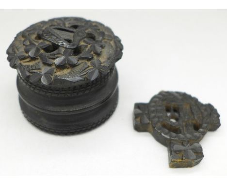 A carved bog oak box with clover and harp to lid and a carved part Celtic cross