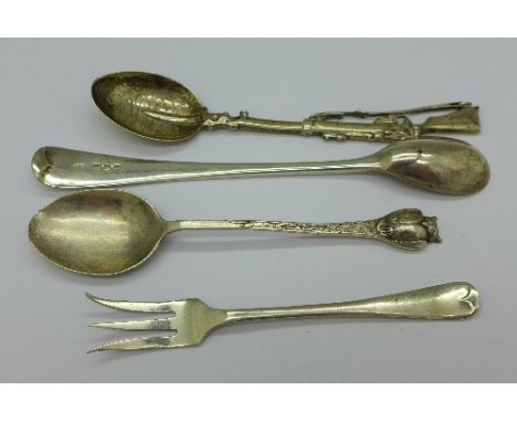 A silver spoon in the form of a rifle, London 1900, by Saunders & Shepherd, a silver mustard spoon, one other spoon and a sil