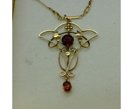 An Art Nouveau garnet set pendant on a 15ct gold chain, 5.2g