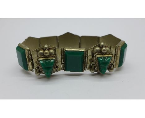 A bracelet marked sterling Mexico set with green stones with Inca design