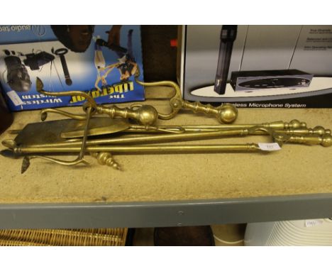 A set of brass fire tools and fire dogs