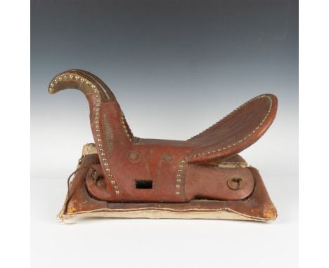 This Middle Eastern saddle has a wood tree constructed with a curved horn and high cantle. The brown leather is decorated wit