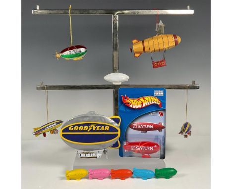 Group of Zeppelin decorations and toys featuring five hanging Christmas airships, five colorful erasers, one Saturn Hot Wheel