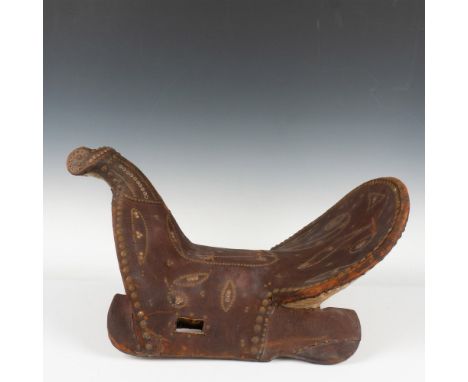 This Middle Eastern saddle has a wood tree constructed with a curved horn and high cantle. The brown leather is decorated wit