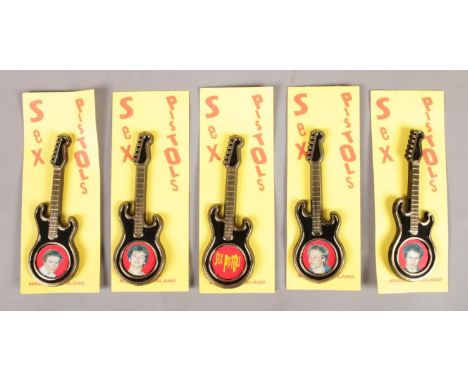 A set of five Sex Pistols plastic guitar brooches, four portrait and one logo.  