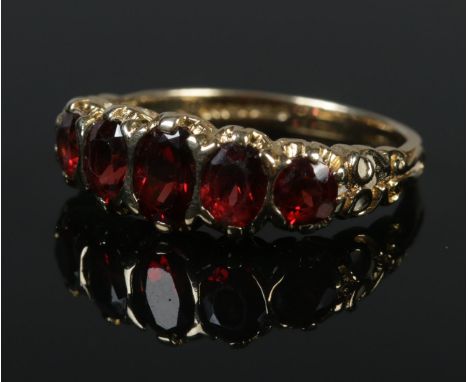 A 9ct gold five stone garnet ring. Size O. 3.92g.  